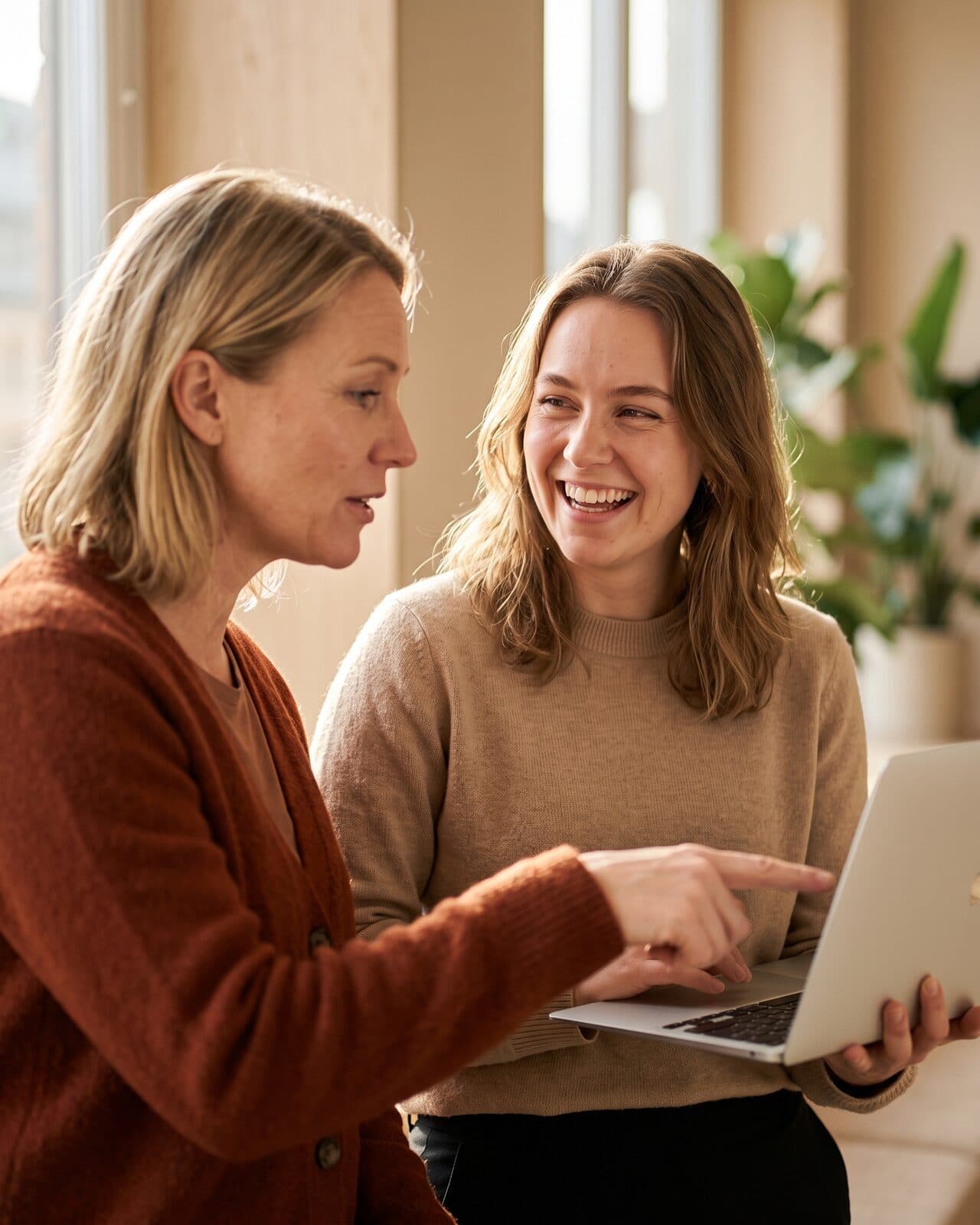 Two recruiters going through candidates on a laptop