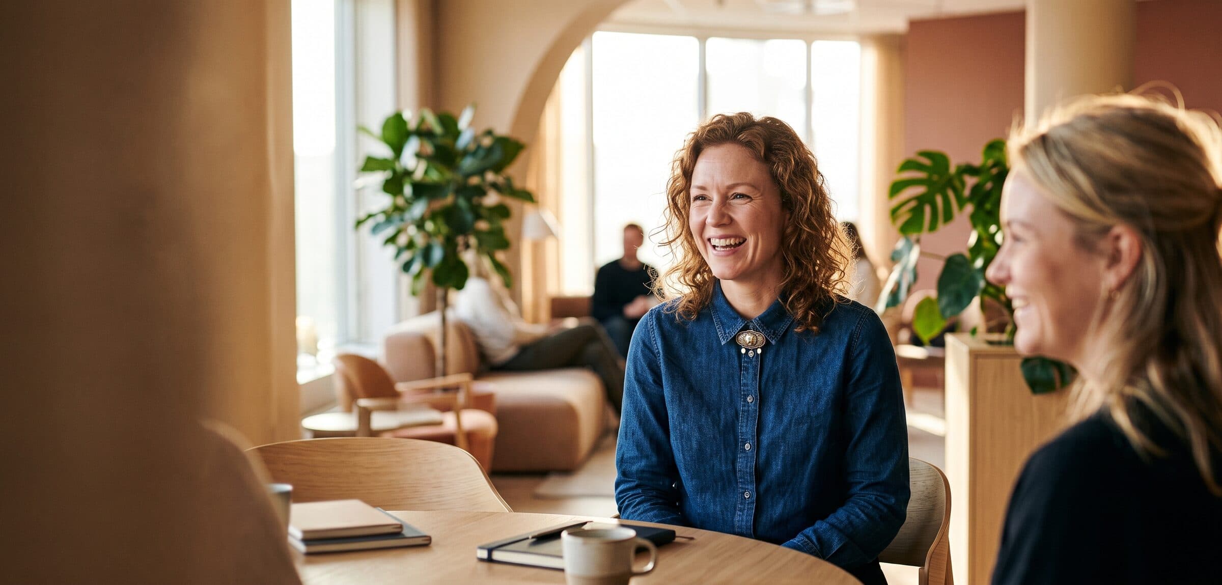Recruiter laughing with a colleague in a bright office